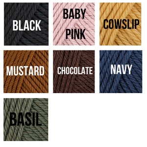 May include: A collection of yarn skeins in various colors, including black, baby pink, mustard, chocolate, navy, and basil.