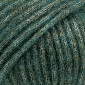 May include: Close-up of a skein of teal and green yarn. The yarn is soft and fluffy, with a subtle sheen.