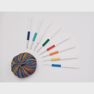 May include: A set of three ceramic mugs with a speckled, matte finish. The mugs are in shades of blue, green, and white. Each mug has a simple, modern design, perfect for coffee or tea.