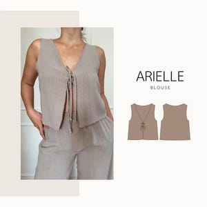 Può includere: Una camicetta senza maniche beige chiaro con scollo a V e chiusura con lacci, abbinata a pantaloni coordinati. L'immagine include anche uno schema della camicetta e il testo "ARIELLE BLOUSE".