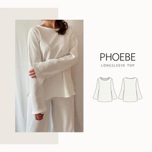 May include: A white long-sleeved top and matching trousers. The top features a boat neck and flared sleeves. The fabric has a ribbed texture. The text "PHOEBE LONGSLEEVE TOP" is displayed in black. Two line drawings of the top are also shown.