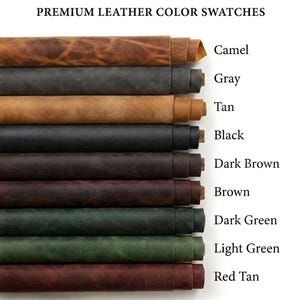 A collection of rolled leather sheets in various colors, including red tan, light green, dark green, brown, dark brown, black, tan, gray, and camel. The colors are labeled with text. The leather appears to be of high quality.
