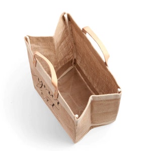 May include: A brown burlap tote bag with leather handles. The bag is empty and the inside is visible. The bag has a black design on the front that says "You're my sunshine".