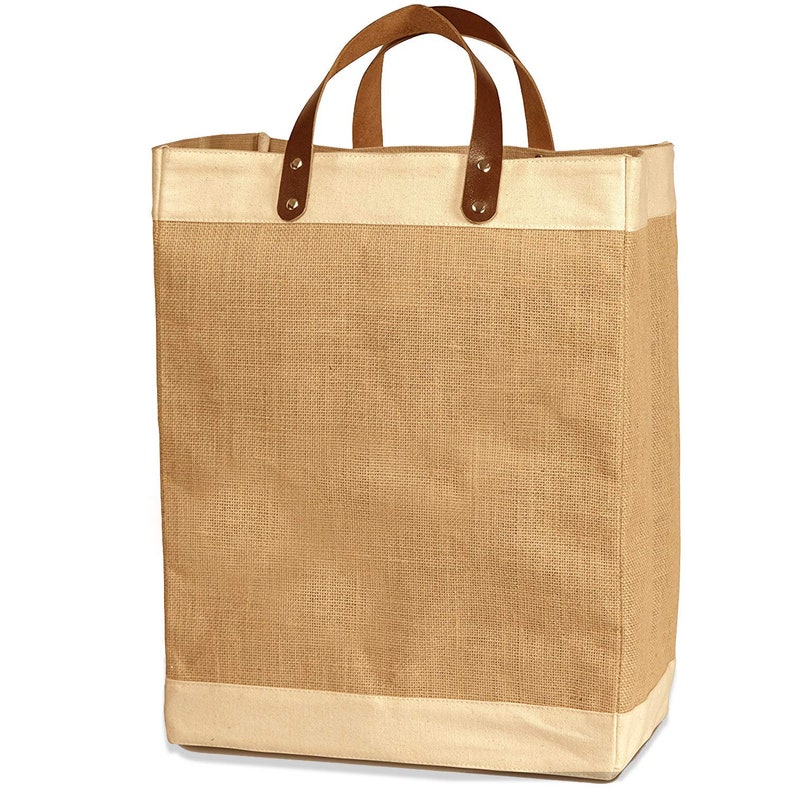 May include: A large, brown burlap tote bag with leather handles and a white canvas trim. The bag has a natural, rustic look and is perfect for carrying groceries, books, or other items.