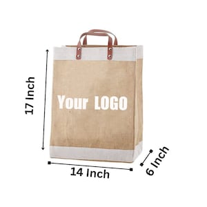 May include: A brown jute tote bag with white trim and brown leather handles. The bag is 17 inches tall, 14 inches wide, and 6 inches deep. The bag has the text "YOUR LOGO" printed on the front.