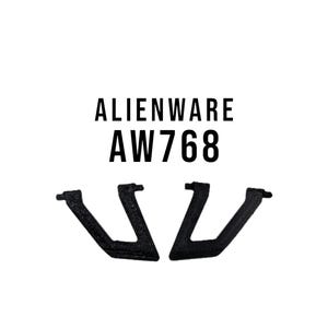Könnte beinhalten: Zwei schwarze Kunststoffhalterungen in U-Form. Die Halterungen sind mit "Alienware AW768" beschriftet.