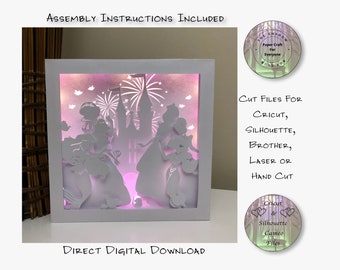 May include: A white light-up box with a pink glow, featuring a paper cut-out design of a castle and princesses. The box is on a wooden surface. The text "ASSEMBLY INSTRUCTIONS INCLUDED" and "DIRECT DIGITAL DOWNLOAD" are visible. The text "CUT FILES FOR CRICUT, SILHOUETTE, BROTHER, LASER OR HAND CUT" is also visible.