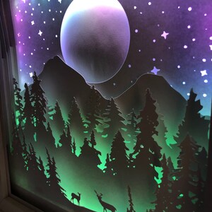 Deer in the Forest Shadow Box SVG design template of a couple walking in the forest with the mountains in the background, can be cut with Cricut, Silhouette Cameo, Brother machines or by hand, designed by The Shadow Box Club