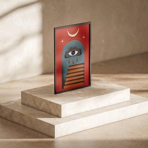 May include: A framed art print with an abstract design. The artwork features a red background, an arched doorway, and a staircase. It includes a crescent moon, a cloud with an eye, and raindrops. The print is displayed on a three-tiered, light-coloured pedestal.