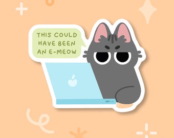 May include: A sticker showing a grey cat with a grumpy face, using a light blue laptop. A speech bubble says "THIS COULD HAVE BEEN AN E-MEOW". The background is peach-coloured with decorative shapes.