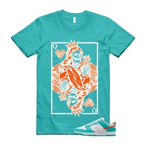 May include: A turquoise t-shirt with a playing card design of a queen with a skull face, crown, and roses in orange and white. A pair of white, turquoise, and orange trainers are at the bottom.