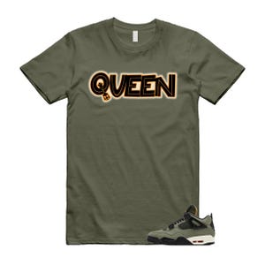 May include: Olive green t-shirt with the word "QUEEN" in black and orange lettering. A pair of green, black, and white sneakers are at the bottom of the image. The shirt is a casual wear item.
