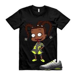 May include: A white ceramic mug with a black handle and the text "But First, Coffee" in a black, handwritten-style font. The mug is on a white surface.