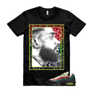 Può includere: T-shirt nero con un ritratto di un uomo con barba e tatuaggi, incorniciato da un motivo paisley rosso, verde e blu. Un paio di scarpe da ginnastica nere, verdi, rosse e gialle sono in basso.