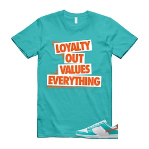 May include: A turquoise t-shirt with the slogan "LOYALTY OUT VALUES EVERYTHING" in orange and white. A pair of white, turquoise, and orange trainers is shown below the shirt.