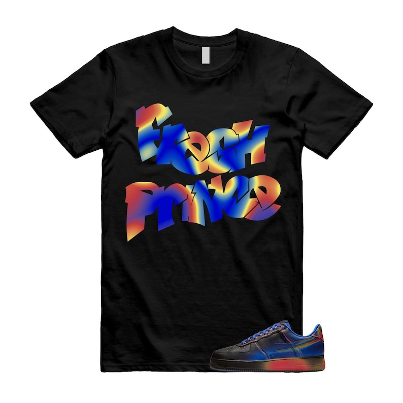 May include: Black t-shirt featuring the words "Fresh Prince" in a vibrant, graffiti-style font. A pair of trainers with a gradient design of blue, red, and yellow are also visible.