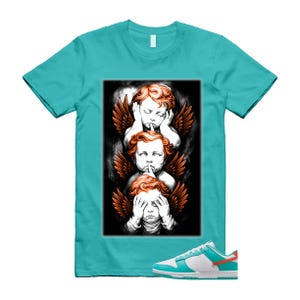 May include: A turquoise t-shirt with a graphic of three cherubs with orange wings, each in a "see no evil, hear no evil, speak no evil" pose. White and turquoise trainers with an orange accent are at the bottom.