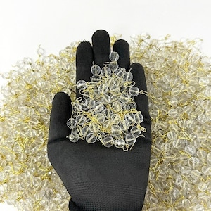 Lote 2 kg de cuentas facetadas Ø10 mm color cristal transparente con pasador y gancho dorados, decoraciones y piezas de araña
