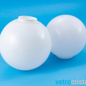 May include: Two white, round, frosted glass lampshades. The lampshades are smooth and have a slightly textured surface.