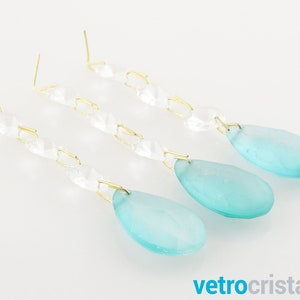 May include: Three strands of crystal beads with teardrop-shaped aqua blue glass pendants.