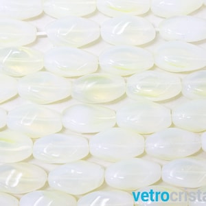 May include: A close-up of a strand of white oval-shaped beads with iridescent shimmer. The beads are arranged in a row and are all the same size and shape.