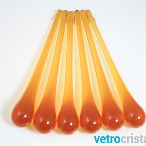 May include: Seven amber glass teardrop-shaped chandelier prisms with a gradient from light to dark amber.