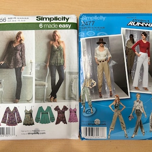 May include: Two Simplicity sewing pattern envelopes. The left envelope, number 3956, shows a long-sleeve top and tank top in various prints. The right envelope, number 2477, features Project Runway designs including trousers, a top, and a jacket.