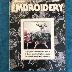 May include: A book titled "Better Homes and Gardens EMBROIDERY" with a black and white floral design. The cover features a photo of a table setting with a floral tablecloth. Text on the cover includes "42 projects with complete how-to".