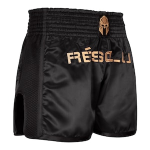 May include: Black Muay Thai shorts with gold embroidery. The shorts feature a side mesh panel and a gold embroidered logo that says "FRESCO_LJ" and a gold embroidered warrior helmet.