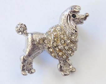 Designer signed Jomaz Goldtone poodle brooch wearing a crown and collar encrusted with crystal Textured metal fur detail.