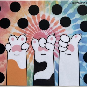 May include: Three cartoon cat paws with different colored fur, reaching up towards a tie-dye background with black polka dots. The text "Debtfreeby43shop" is in the top right corner.