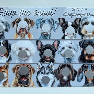 May include: A card with the text "Boop the snoot!" and "$65 1-9 Debtfreeby433shop" printed on it. The card features a grid of nine illustrated dog faces with a gray circle covering each dog's nose.