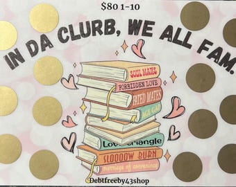May include: A pink and white card with gold circles and the text "IN DA CLURB, WE ALL FAM."  The card also features a stack of books with titles like "Soul Mates", "Forbidden Love", "Fated Mates", "Age Gap", "Love Triangle", "Slooooow Burn", and "Marriage of Convenience".