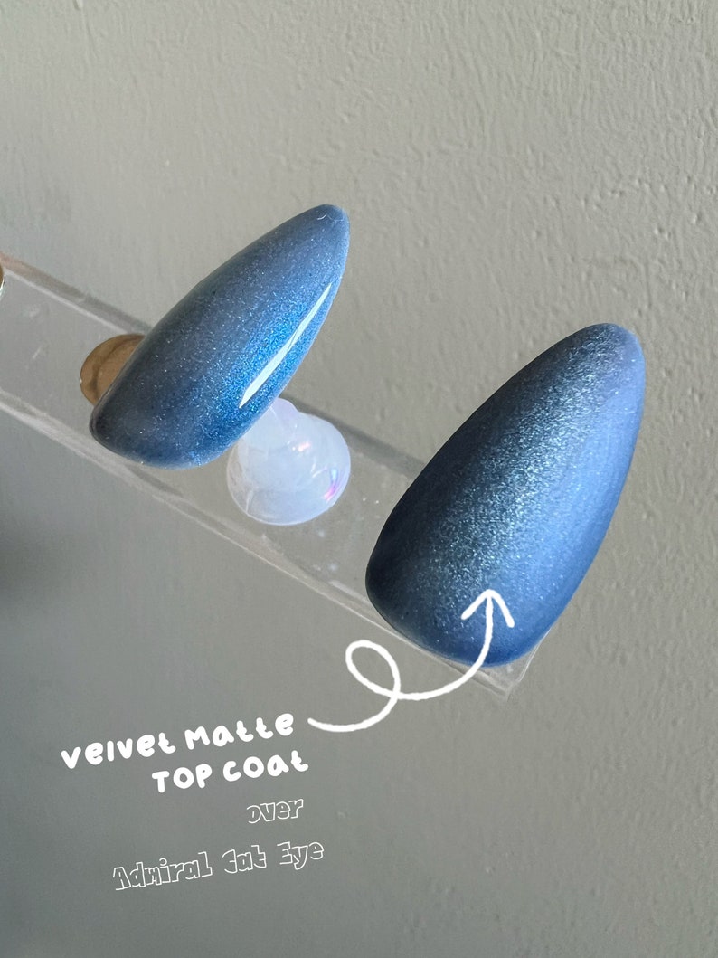 May include: Two nail polish samples, one with a velvet matte top coat over a blue glitter polish, labeled "velvet matte top coat over Admiral Cat Eye"