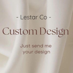 May include: Image features the text "- Lestar Co - Custom Design Just send me your design" in a soft brown color. The text is set against a backdrop of flowing, off-white fabric, creating a clean and elegant aesthetic.