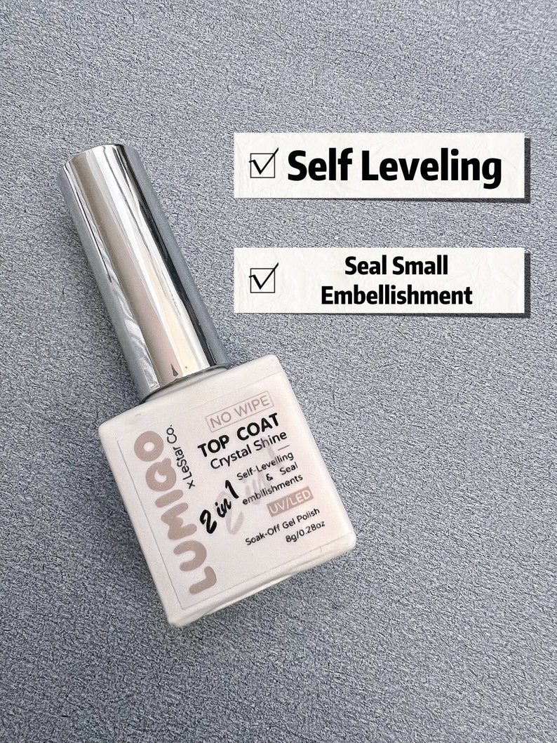 May include: A clear bottle of Lumigo 2 in 1 Top Coat Crystal Shine soak-off gel polish. The bottle is labelled with the brand name, product name, and features. The bottle is 8g (0.28 oz).