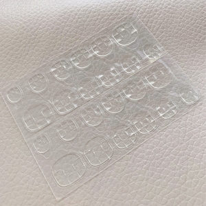 May include: A sheet of clear adhesive tabs for attaching false nails. The tabs are arranged in rows and are designed to be used on all ten fingernails.