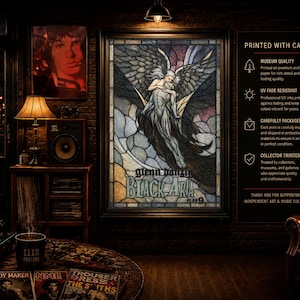 May include: A framed wall poster featuring a stained glass style illustration of a winged figure embracing another, with the text Glenn Danzig Black Aria Plan 9. The artwork is displayed in a dark room with a record player, lamps, and magazines.