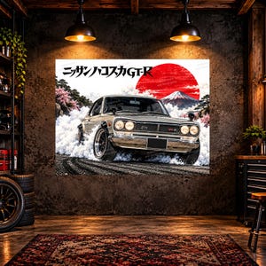 May include: A wall art print featuring a silver Nissan Hakosuka GT-R drifting on a track. The background displays a large red sun, Mount Fuji, and cherry blossom trees. The Japanese text reads Nissan Hakosuka GT-R above the car.