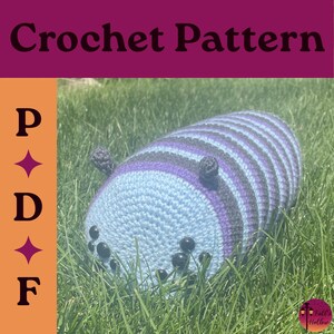 May include: A crochet pattern PDF featuring a cylindrical stuffed creature with horizontal stripes in light blue, purple, and dark gray. The creature has two small dark gray antennae and six black circular eyes on its front face.