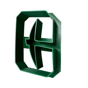 May include: A green plastic cookie cutter shaped like a letter "B" with a curved design in the center.