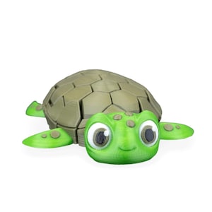 May include: A 3D-printed turtle figurine. It has a green head and flippers, and an olive-green segmented shell. The turtle has large eyes and a smiling mouth, giving it a friendly appearance.