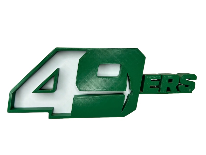 May include: Green 3D plastic 49ers logo with white lettering.