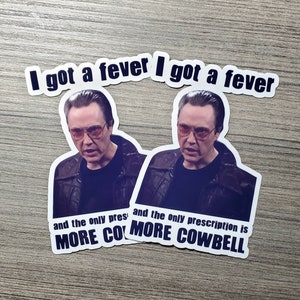 May include: Two stickers featuring a photo of Nicolas Cage with the text "I got a fever I got a fever and the only prescription is MORE COWBELL".