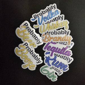 May include: A collection of colorful stickers with the words "Probably Vodka", "Probably Whiskey", "Probably Beer", "Probably Booze", "Probably Brandy", "Probably Tequila", "Probably Rum", and "Probably Gin".
