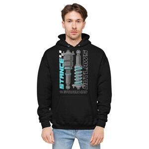 May include: Black hooded sweatshirt with a graphic print of two car suspension parts in blue and gray. The text "STANCE" and "OUTLAWS" is printed vertically on either side of the graphic.