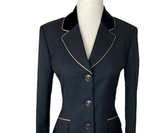 May include: A black riding jacket with a velvet collar and gold trim. The jacket has a single-breasted closure with four buttons.