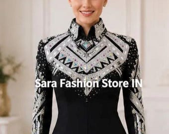 May include: A black long-sleeved show jacket featuring a high collar and intricate silver geometric embellishments across the chest and sleeves. The text SARA FASHION STORE IN is visible on the garment and the upper portion of the image.