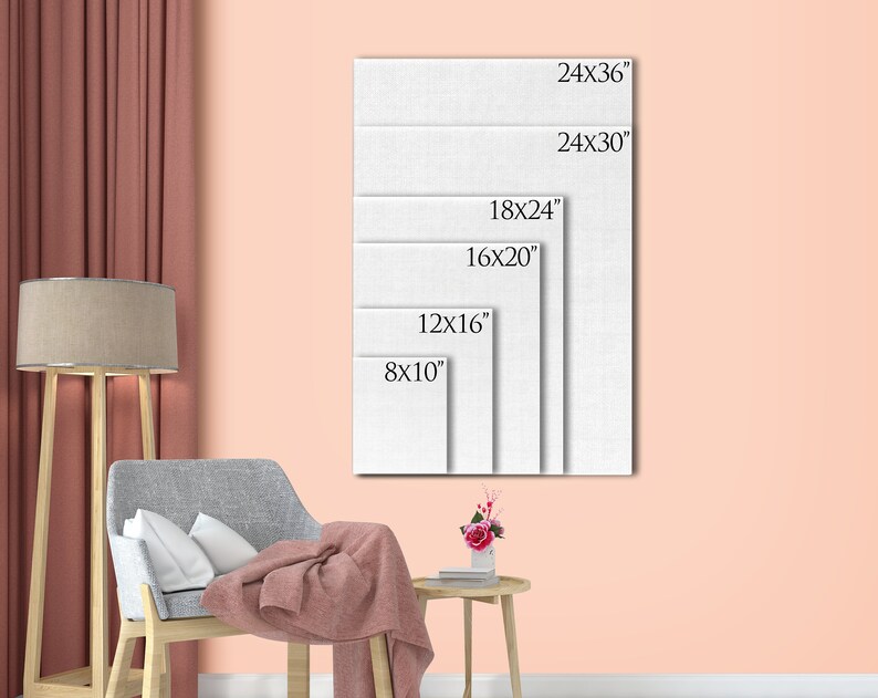 May include: A stack of white canvas art prints in various sizes, including 8x10 inches, 12x16 inches, 16x20 inches, 18x24 inches, 24x30 inches, and 24x36 inches. The prints are displayed against a peach-colored wall, with a chair, lamp, and side table in the foreground.