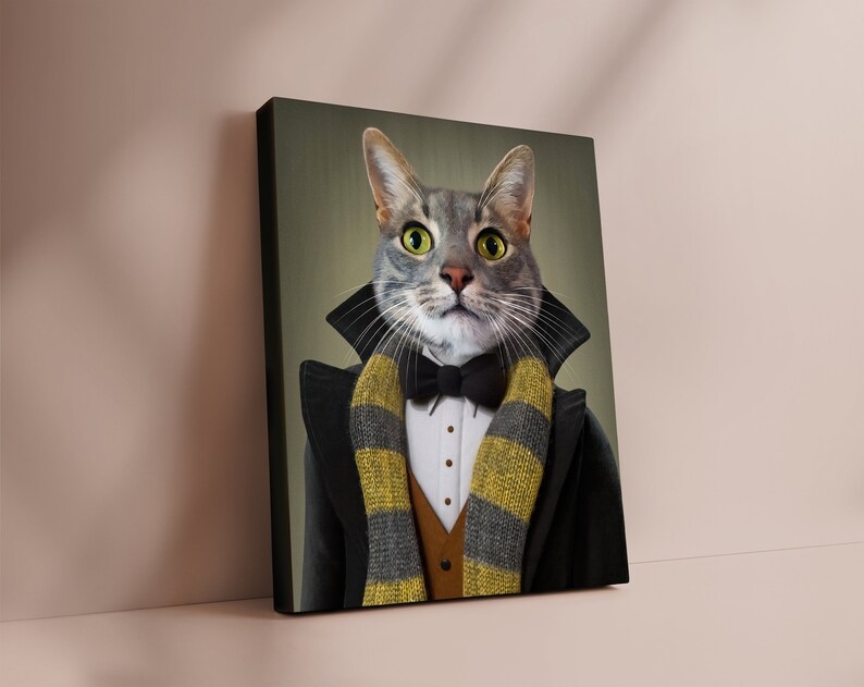 May include: A canvas print featuring a gray tabby cat dressed in formal attire. The cat wears a black tuxedo coat, a bow tie, and a striped scarf in yellow and gray. The cat has bright green eyes and a serious expression.